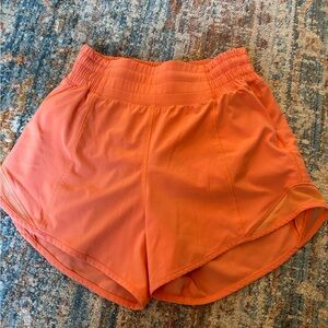 Orange Lululemon hotty hot 4” shorts